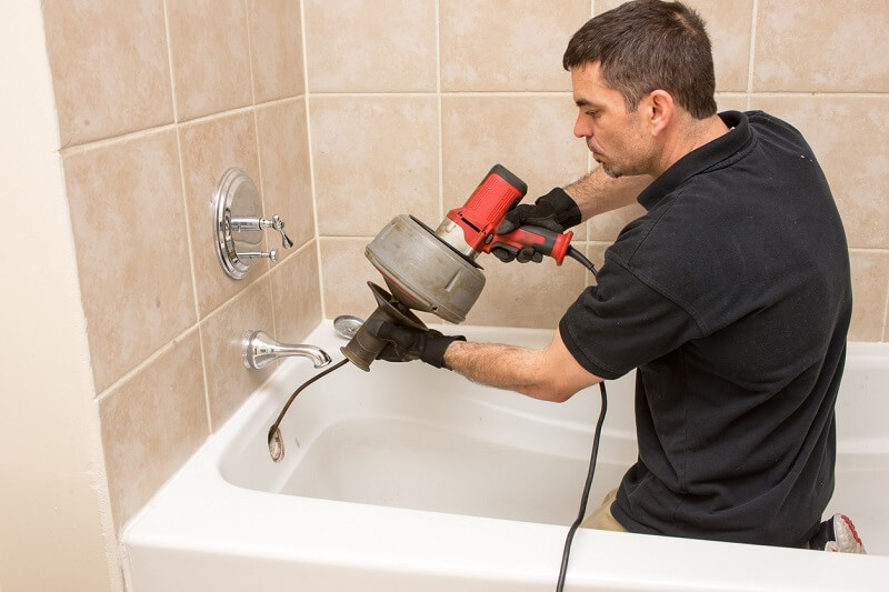 plumber using snake